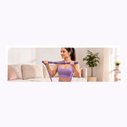 Woman using the FitEase purple toning bar at home
